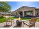 Inviting backyard featuring a cozy fire pit and outdoor seating area, perfect for entertaining guests at 7576 W Quail Ave, Glendale, AZ 85308