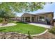 Well manicured backyard with green grass, a covered patio, and a built-in BBQ at 7576 W Quail Ave, Glendale, AZ 85308