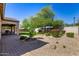Spacious backyard with a mix of artificial turf, desert landscaping, and a covered patio, perfect for outdoor living at 7576 W Quail Ave, Glendale, AZ 85308