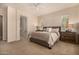 Comfortable bedroom with neutral tones, large windows, and ensuite bathroom at 7576 W Quail Ave, Glendale, AZ 85308