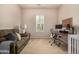 Sun-filled room featuring a sleeper sofa and desk perfect for a workspace at 7576 W Quail Ave, Glendale, AZ 85308