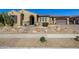 Charming home featuring a desert landscape, arched entryway, and colorful potted plants at 7576 W Quail Ave, Glendale, AZ 85308