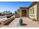 Exterior featuring a front courtyard, arched doorway, and a brick driveway at 7576 W Quail Ave, Glendale, AZ 85308