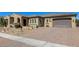 Charming home with a well-manicured desert landscape, brick paver driveway, and a welcoming arched entryway at 7576 W Quail Ave, Glendale, AZ 85308