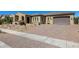 Attractive home with a desert landscaped front yard, brick paver driveway, and a two-car garage at 7576 W Quail Ave, Glendale, AZ 85308