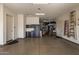 Bright open garage area with epoxy flooring, storage cabinets and ladder at 7576 W Quail Ave, Glendale, AZ 85308