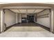 An open garage area with epoxy flooring, built-in cabinets and organized storage solutions at 7576 W Quail Ave, Glendale, AZ 85308