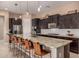 Modern kitchen features dark cabinets, granite counters, stainless appliances, and island seating at 7576 W Quail Ave, Glendale, AZ 85308