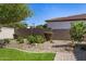Beautiful desert landscaping with various cacti, flowering bushes, and decorative gravel, creating a low-maintenance yard at 7576 W Quail Ave, Glendale, AZ 85308