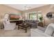 Comfortable living room featuring plush seating, a large window, and stylish decor at 7576 W Quail Ave, Glendale, AZ 85308