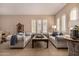 Cozy living room featuring natural light, comfortable couches, and stylish decor at 7576 W Quail Ave, Glendale, AZ 85308