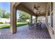 Covered patio with brick pavers, an outdoor dining set, and a manicured backyard at 7576 W Quail Ave, Glendale, AZ 85308