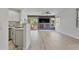 Open living area with gray accent wall, built-in fireplace, ceiling fan, kitchen view and sliding door to balcony at 7887 N 16Th St # 130, Phoenix, AZ 85020