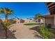 Spacious backyard featuring desert landscaping, tall palm trees, and a grassy area for outdoor enjoyment at 836 W Watson Dr, Tempe, AZ 85283