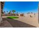 Desert landscaped backyard includes a small grassy area surrounded by gravel for low maintenance at 836 W Watson Dr, Tempe, AZ 85283