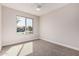 Well-lit bedroom with neutral walls, plush carpet, and a window overlooking the neighborhood at 836 W Watson Dr, Tempe, AZ 85283