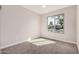 Bedroom with neutral walls, plush carpet, and a window overlooking the street at 836 W Watson Dr, Tempe, AZ 85283