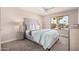Cozy bedroom boasts a large window, neutral décor, and plush carpeting for ultimate comfort at 836 W Watson Dr, Tempe, AZ 85283