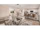 Open-concept dining area showcases stylish table, chairs, lighting, and seamless flow to the adjacent kitchen and living area at 836 W Watson Dr, Tempe, AZ 85283
