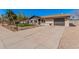 Well-maintained home with tidy front yard, xeriscaping, and a spacious driveway leading to a single car garage at 836 W Watson Dr, Tempe, AZ 85283