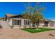 Well-maintained home with desert landscaping, a small grassy area, and mature tree providing shade at 836 W Watson Dr, Tempe, AZ 85283