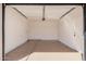 Clean, epoxy-floored garage featuring ample space, a garage door and pedestrian door at 836 W Watson Dr, Tempe, AZ 85283