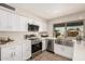 Well-lit kitchen with new stainless steel appliances, light countertops, and a farmhouse-style sink at 836 W Watson Dr, Tempe, AZ 85283