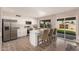 Bright kitchen features stainless steel appliances, white cabinets, and an island with counter seating at 836 W Watson Dr, Tempe, AZ 85283