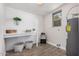Well-organized laundry room with white shiplap walls, wood tile floors and natural light at 836 W Watson Dr, Tempe, AZ 85283