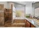 This bright bathroom features a walk-in shower, soaking tub, and sleek granite counters at 9098 N 117Th Way, Scottsdale, AZ 85259