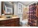 This bathroom offers a decorative bowl sink, dark cabinets, and a shower/tub combo at 9098 N 117Th Way, Scottsdale, AZ 85259