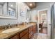This bathroom features a long granite counter, double sinks, and dark stained cabinets at 9098 N 117Th Way, Scottsdale, AZ 85259