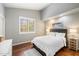 Cozy bedroom features a ceiling fan, wood floors, shutters, and neutral decor at 9098 N 117Th Way, Scottsdale, AZ 85259