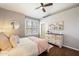 Cozy bedroom features a ceiling fan, wood floors, shutters, and a double dresser at 9098 N 117Th Way, Scottsdale, AZ 85259