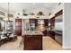 Gourmet kitchen with stainless steel appliances, dark wood cabinets, and granite countertops at 9098 N 117Th Way, Scottsdale, AZ 85259