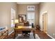 This office features a large wooden desk, chair, shutters, and a neutral color palette at 9098 N 117Th Way, Scottsdale, AZ 85259
