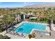 Resort-style pool with lap lanes, lounge chairs and umbrellas surrounded by mature palm trees at 9098 N 117Th Way, Scottsdale, AZ 85259