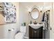 This powder room offers a gorgeous dark vanity and fixtures, with a beautiful art piece at 9098 N 117Th Way, Scottsdale, AZ 85259