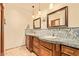 Bathroom with a double sink vanity, decorative mirrors, and stylish tile at 9121 W Quail W Trl, Queen Creek, AZ 85144
