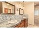 Luxurious bathroom features dual vanities with custom mirrors and mosaic tile accents at 9121 W Quail W Trl, Queen Creek, AZ 85144