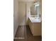 Shows a bathroom with a white sink and vanity, medicine cabinet and door to the left at 9121 W Quail W Trl, Queen Creek, AZ 85144