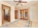 Bedroom featuring a ceiling fan, french doors, and an ensuite bathroom at 9121 W Quail W Trl, Queen Creek, AZ 85144