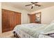 Bright bedroom with a ceiling fan, a sliding door closet, and an ensuite bathroom at 9121 W Quail W Trl, Queen Creek, AZ 85144