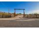 Gated driveway entrance leading to a rural property with a desert landscape and mountain views at 9121 W Quail W Trl, Queen Creek, AZ 85144