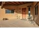 Charming outdoor entryway with seating and desert-themed decorations at 9121 W Quail W Trl, Queen Creek, AZ 85144