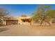 Exterior view of a home with stucco siding, a two-car garage, and desert landscaping at 9121 W Quail W Trl, Queen Creek, AZ 85144