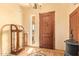 Entryway showcases a decorative wood door, tile flooring, and curated decor accents at 9121 W Quail W Trl, Queen Creek, AZ 85144