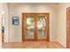 Hallway featuring paneled french doors leading to an outdoor area and a decorative painting at 9121 W Quail W Trl, Queen Creek, AZ 85144