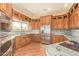 Spacious kitchen with wooden cabinets, granite countertops, and stainless steel appliances at 9121 W Quail W Trl, Queen Creek, AZ 85144