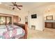 Spacious main bedroom with wood-style bed frame, and en-suite bathroom at 9121 W Quail W Trl, Queen Creek, AZ 85144